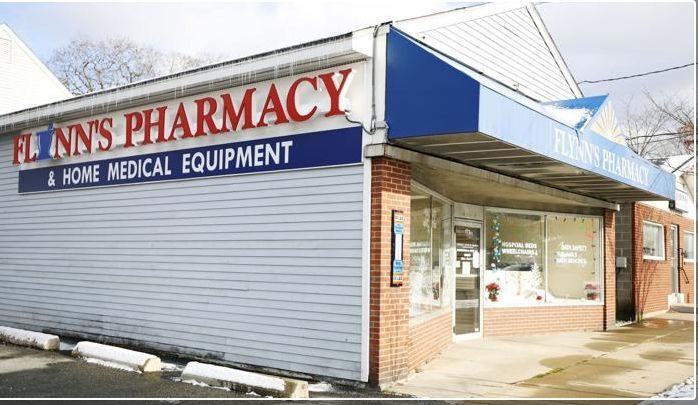 Finn’s Pharmacy storefront with blue awning and “Home Medical Equipment” sign