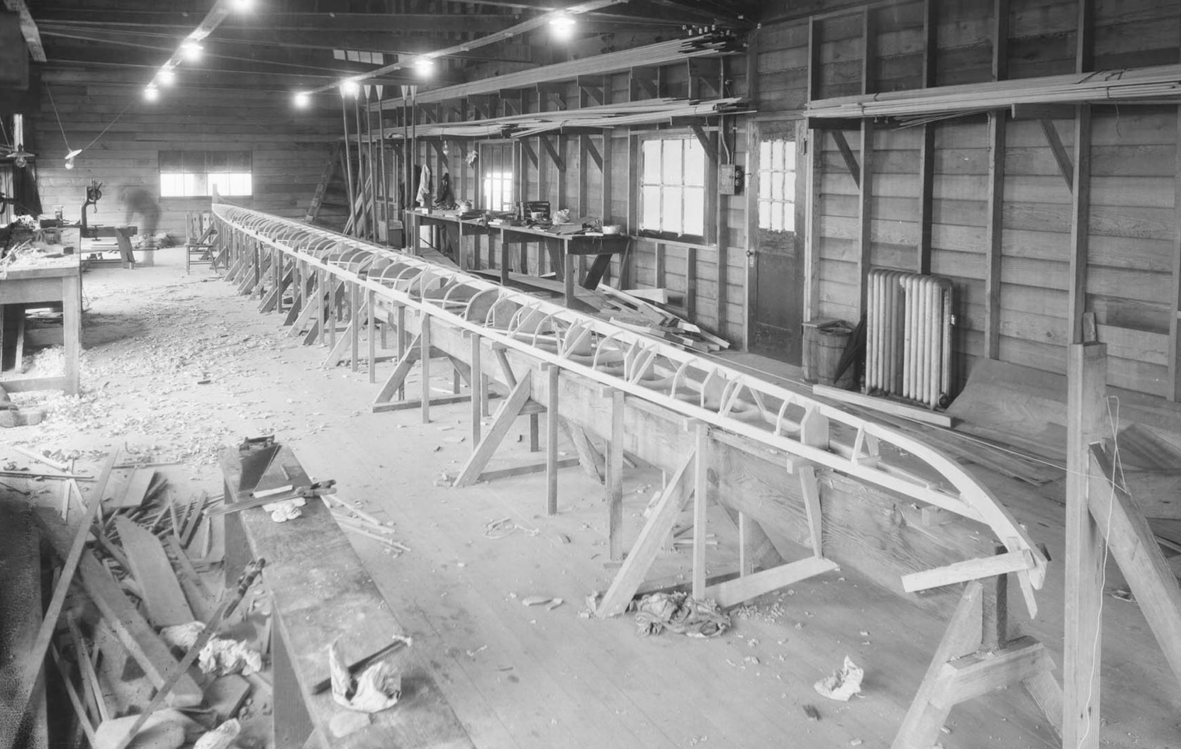 Historic 1923 photo of George Pocock’s workshop in the UW ASUW Shell House, with racing shell frame.