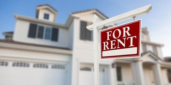 A for rent sign in front of a house