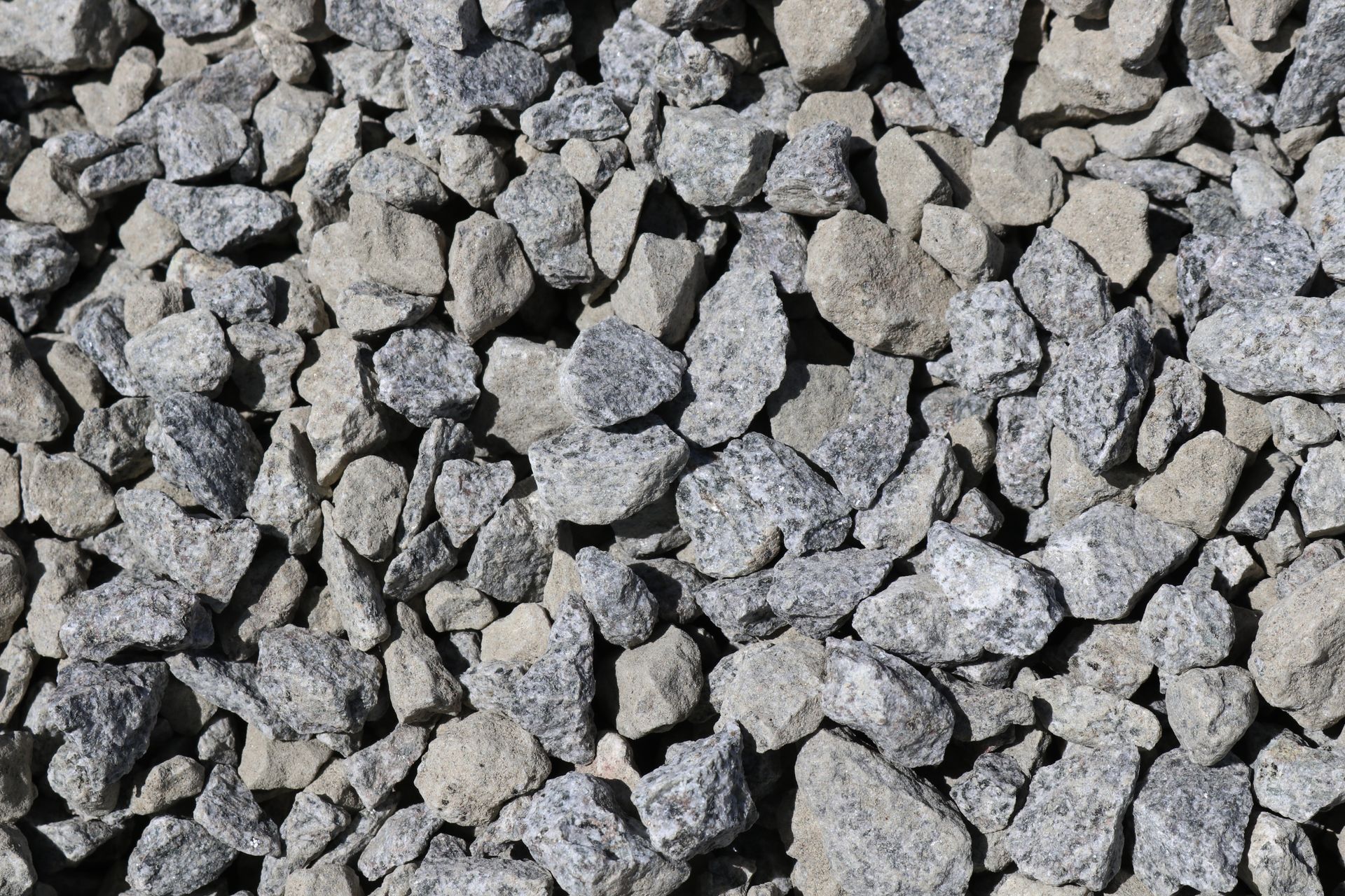 A pile of gravel is sitting on the ground.