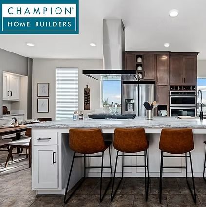 Modern kitchen with white island, brown barstools, dark cabinets, and open dining area