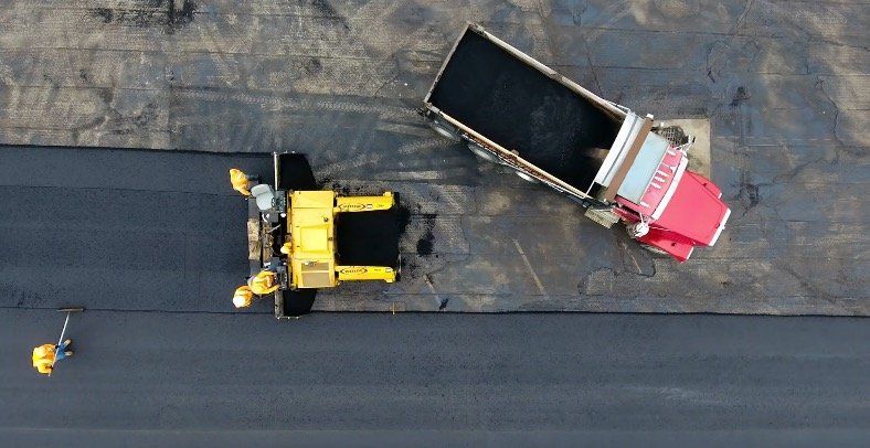 Greater Milwaukee Asphalt Paving works on laying down fresh asphalt for a commercial business in Wauwatosa.