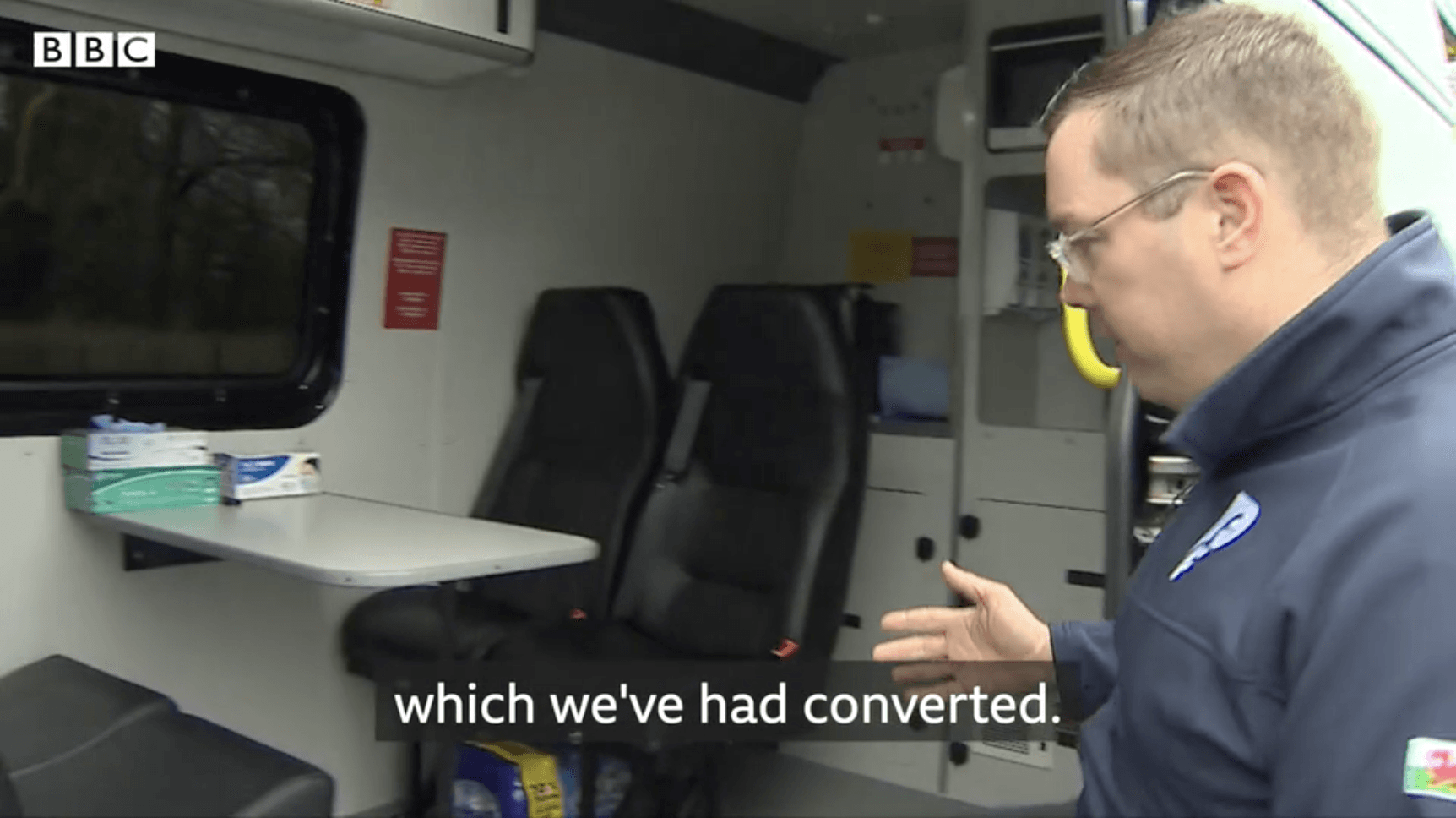 Police officer looking inside of new van