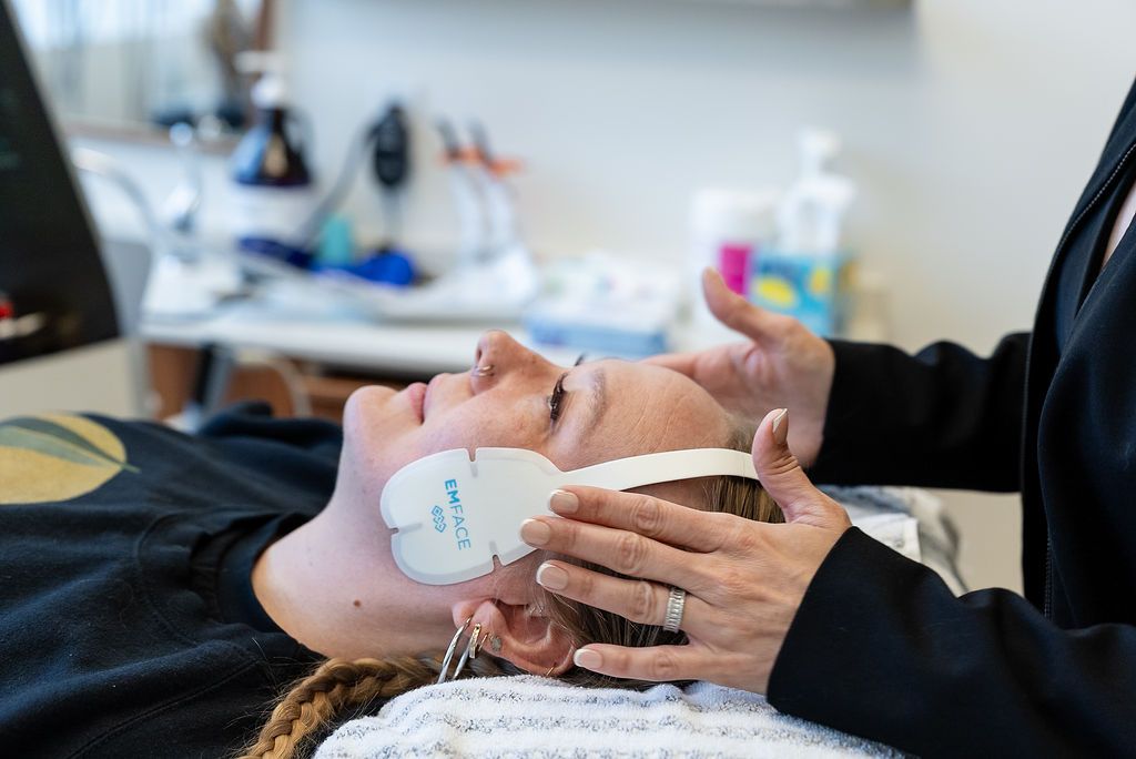 Dentist performing a TMJ and facial aesthetics treatment on a patient in a dental office