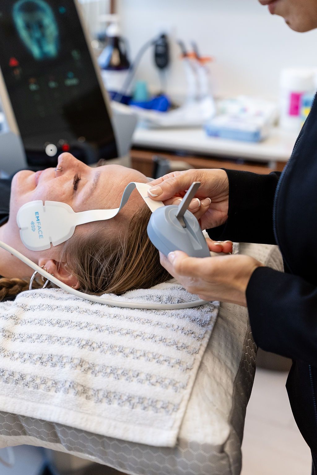Person receiving a facial treatment while lying back with eye patches in a spa setting