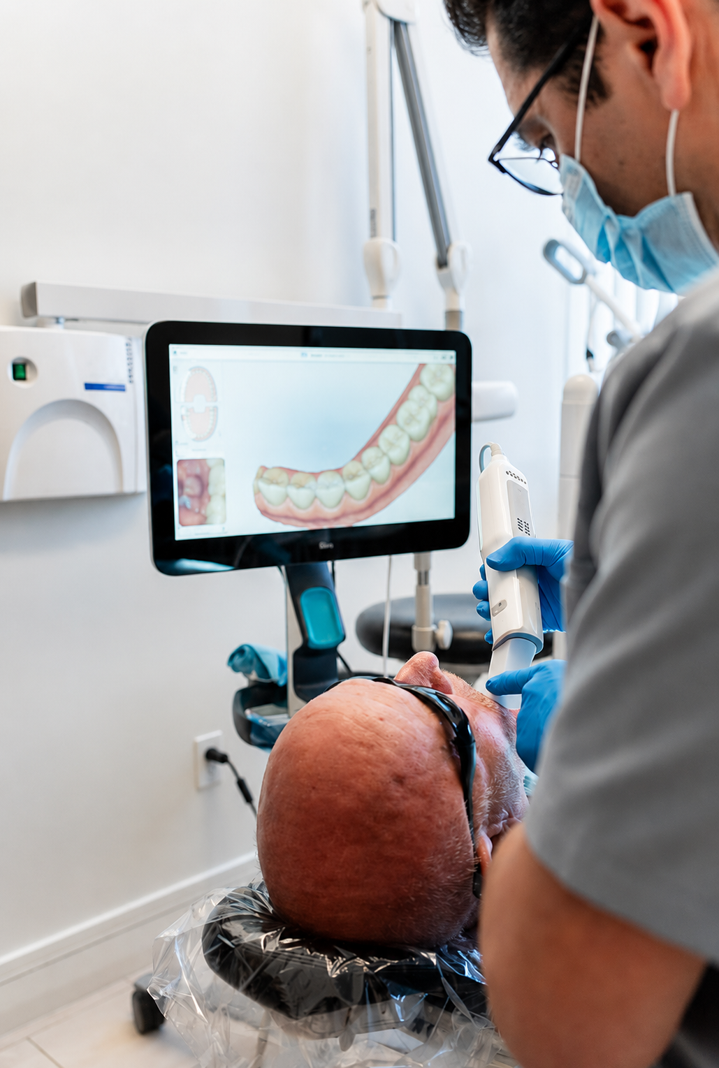 Dentist using a monitor to examine a patient during a dental procedure