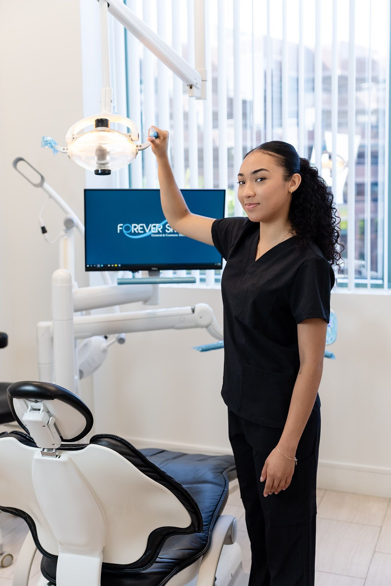 A dental assistant preparing a treatment room at a Los Angeles dental office