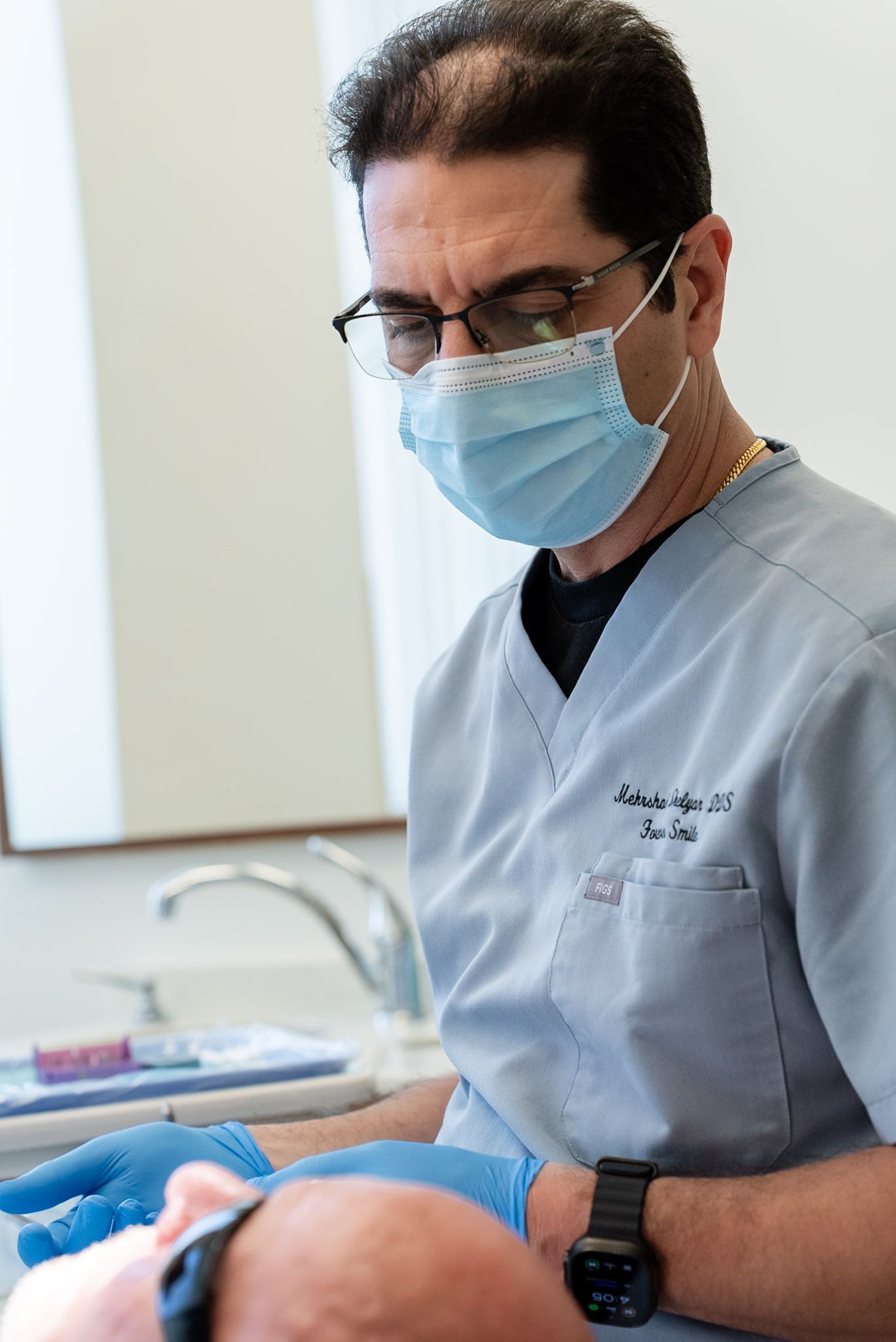 Dentist checking a patient's teeth during a cleaning and checkup visit
