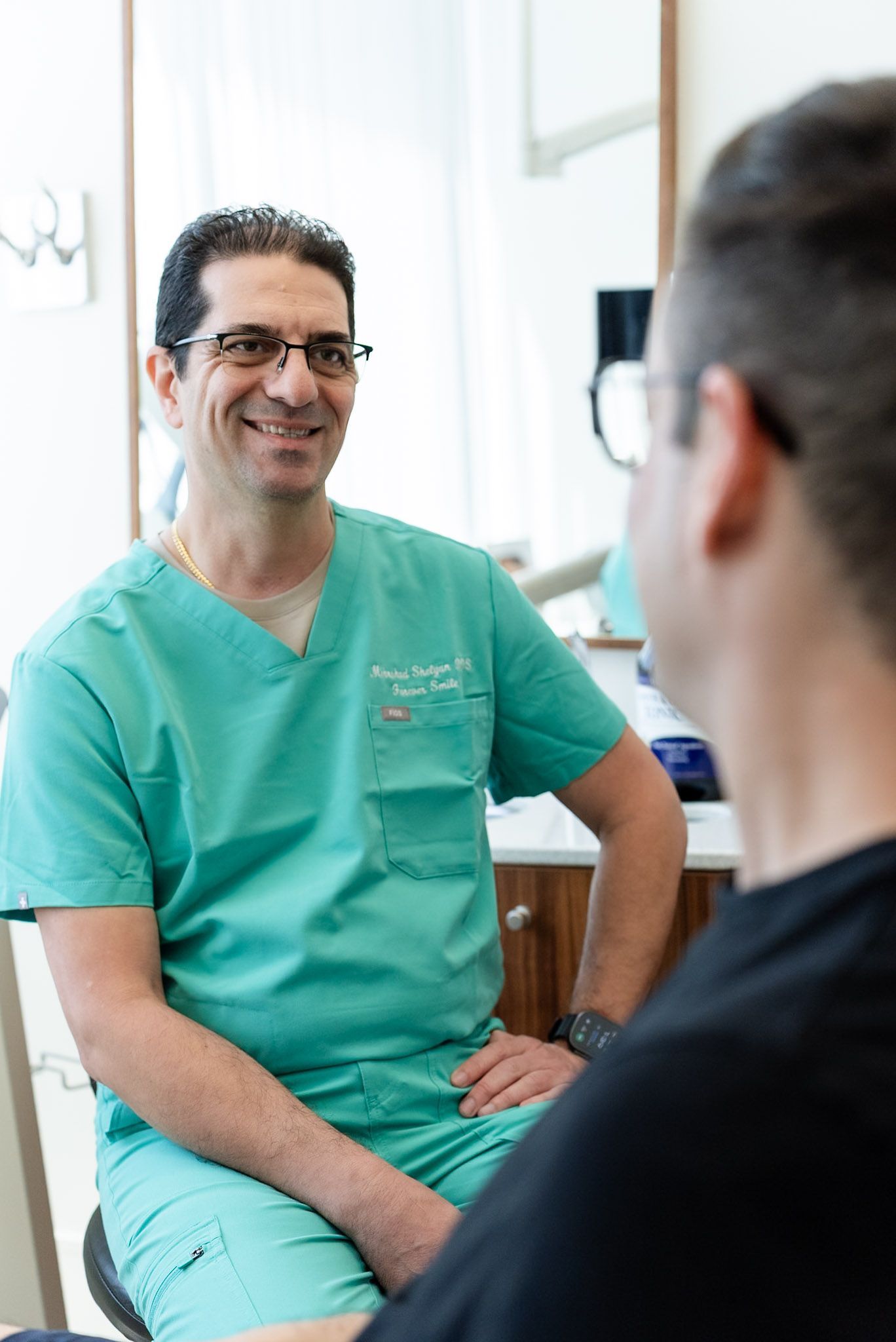 Dr. Shelyan chatting with a patient at a checkup, Los Angeles dental office