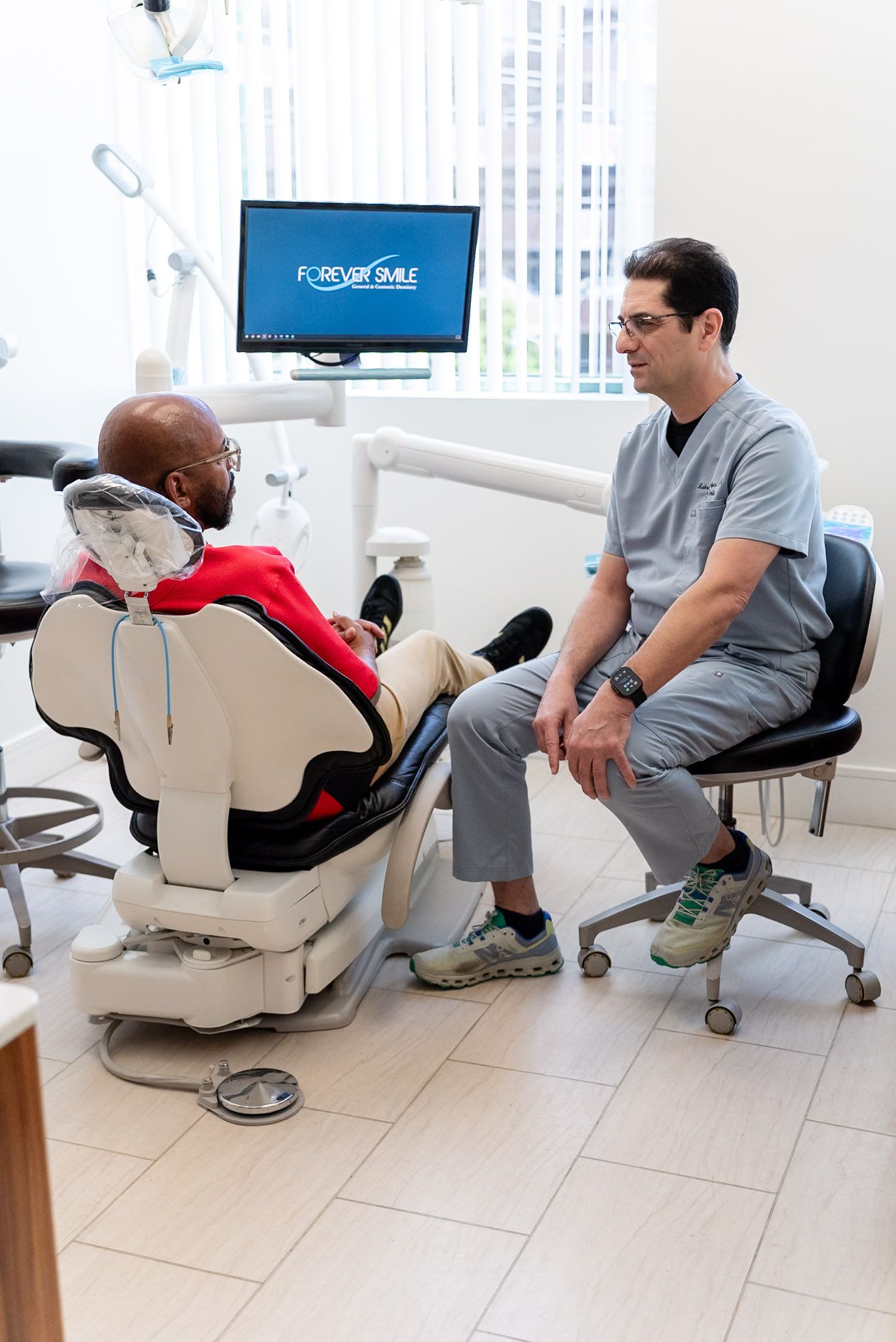 Dr. Shelyan talking with a patient about gum health, Los Angeles dental office