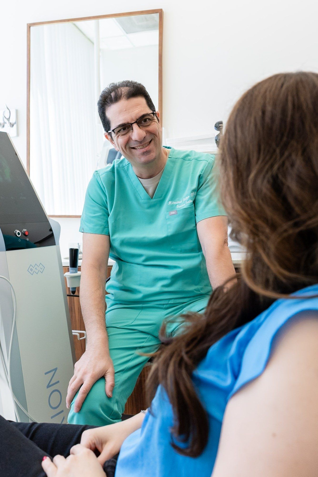 Dr. Shelyan smiling and talking with a patient during a checkup visit