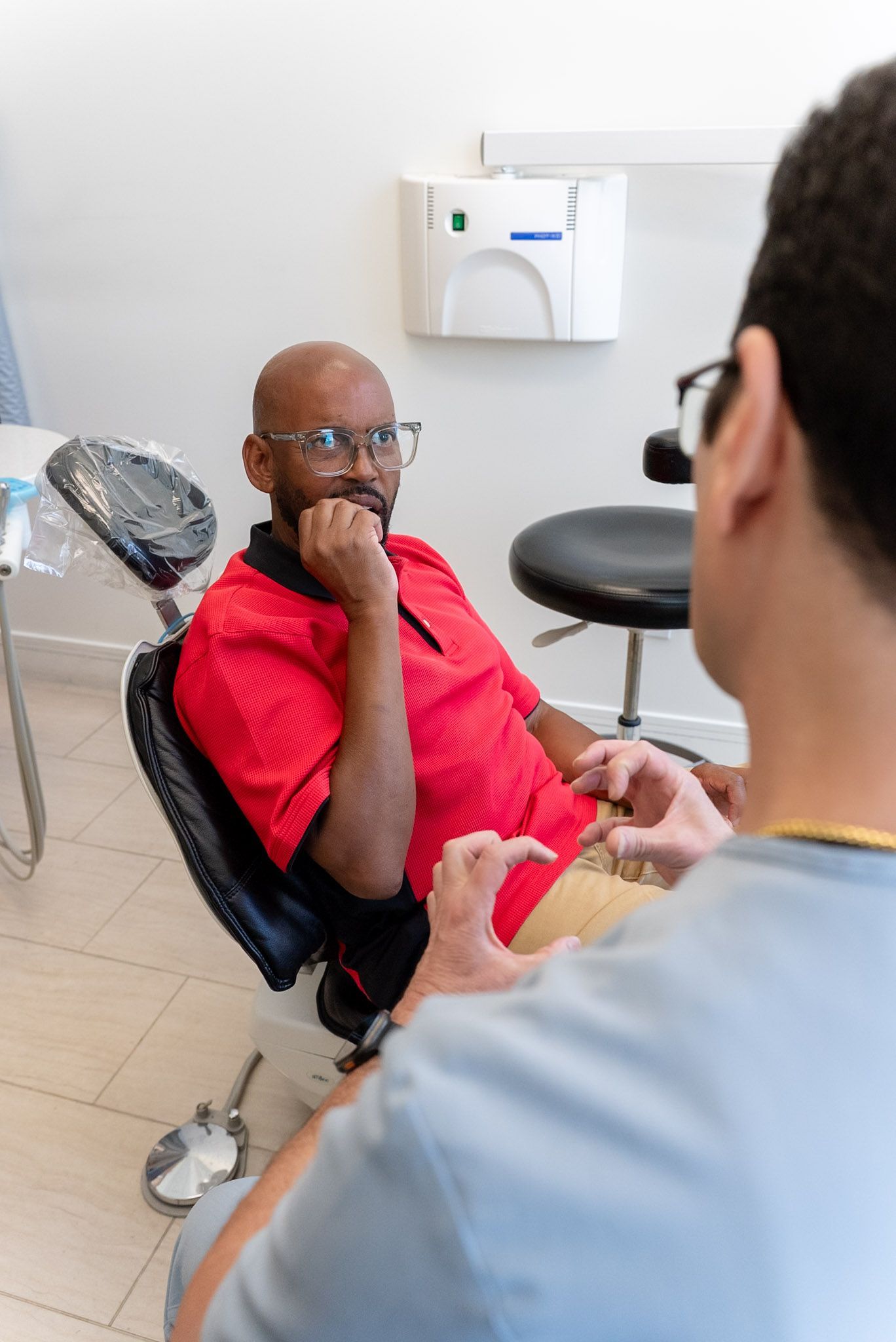 A patient listening during a gum health visit with a Los Angeles dentist