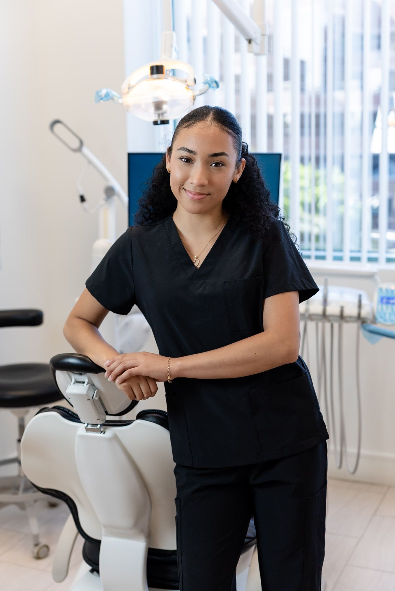 Jenecia, dental assistant, smiling in a Forever Smile treatment room in Los Angeles