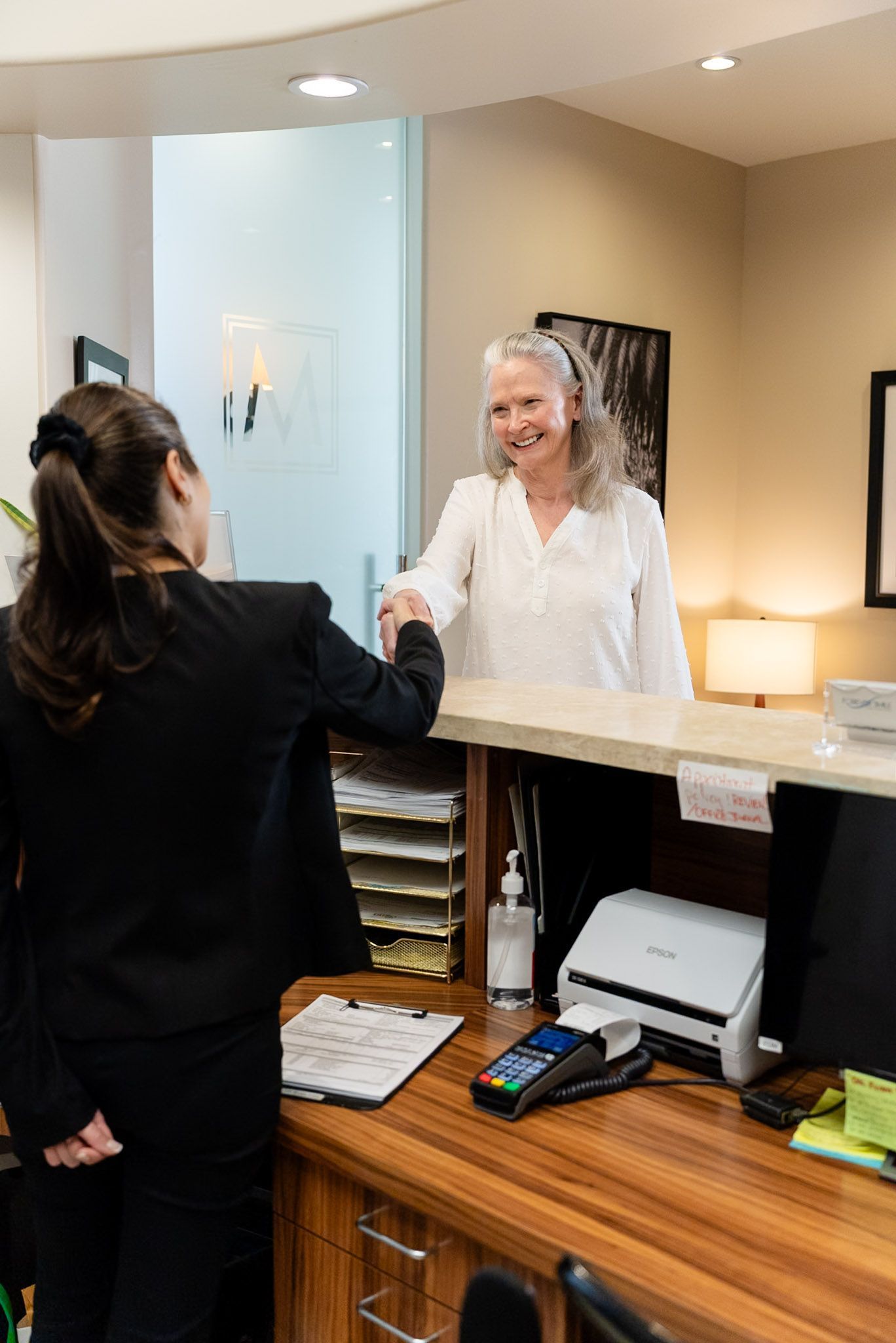 A patient is welcomed at the Forever Smile front desk in Los Angeles
