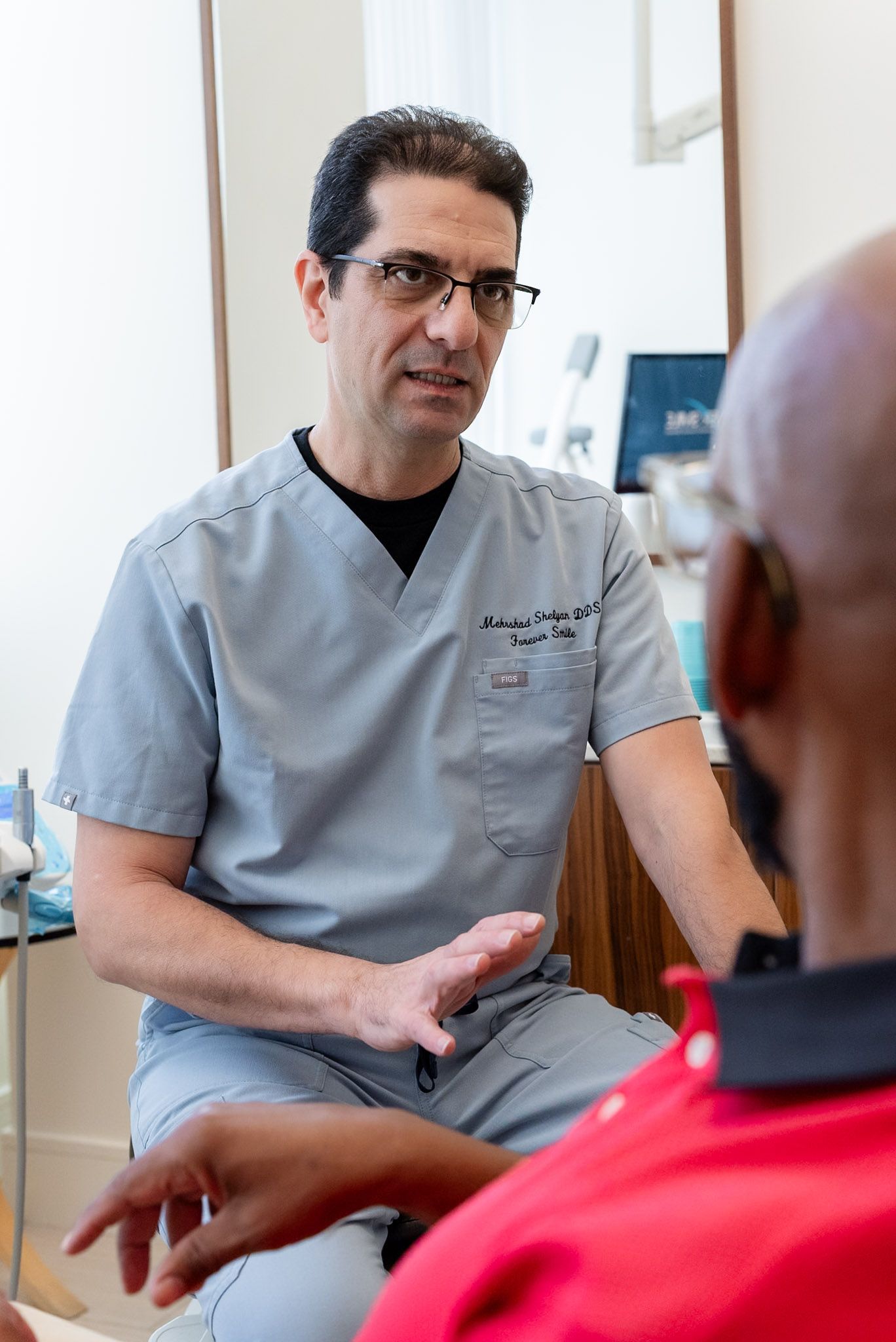 Dr. Shelyan explaining Pinhole gum rejuvenation at a Los Angeles dental office