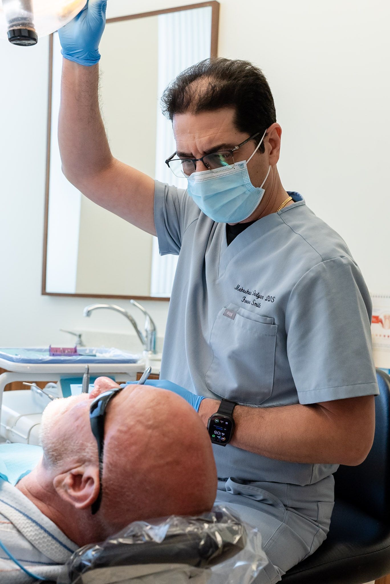 Dentist adjusting the light before a tooth-colored filling