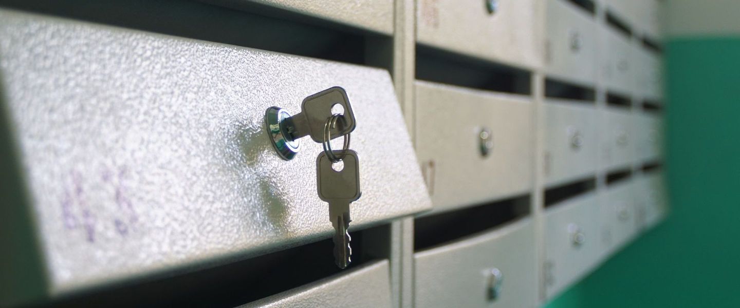 A close up of a mailbox with a key in it.