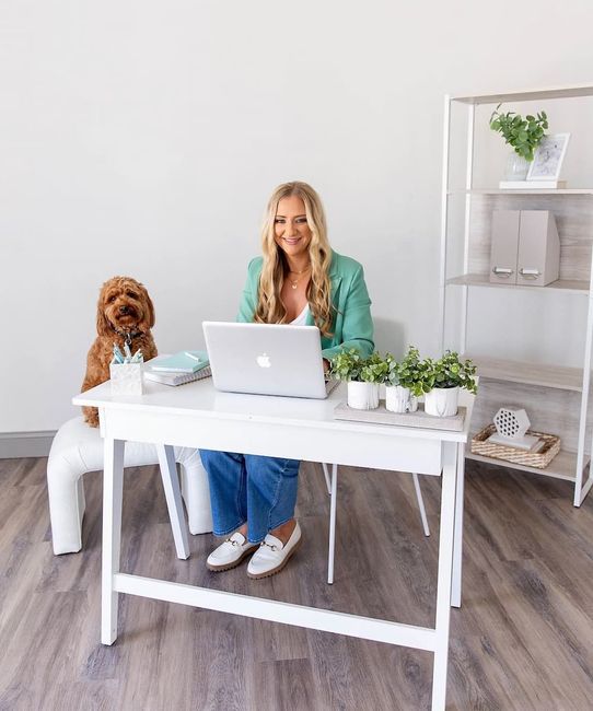 Kim Diehl Insurance Agent sits at a desk with a dog and a laptop