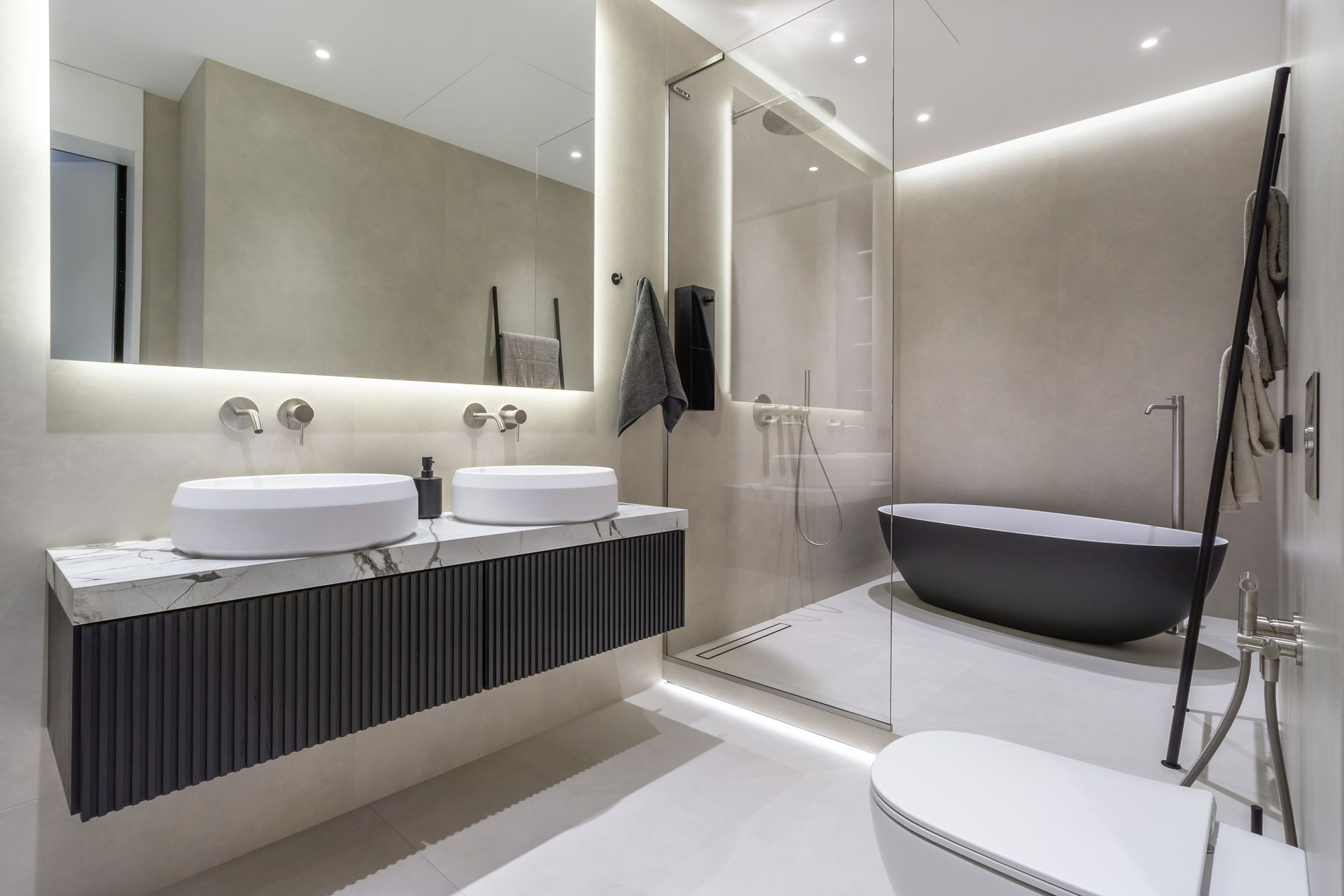 Modern bathroom with double sink vanity, freestanding bathtub, and glass shower in a bright minimalist design