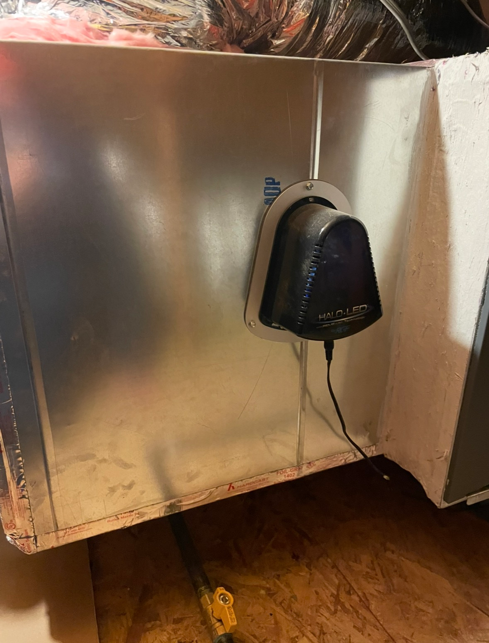 Air conditioning units with toolbox and gloves in backyard.