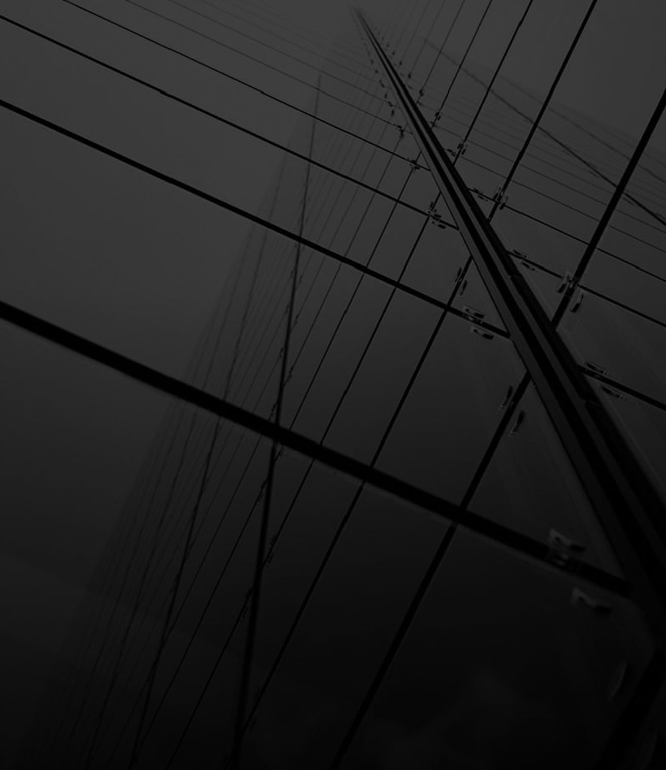 Dark abstract view of power lines and utility poles stretching across a cloudy sky