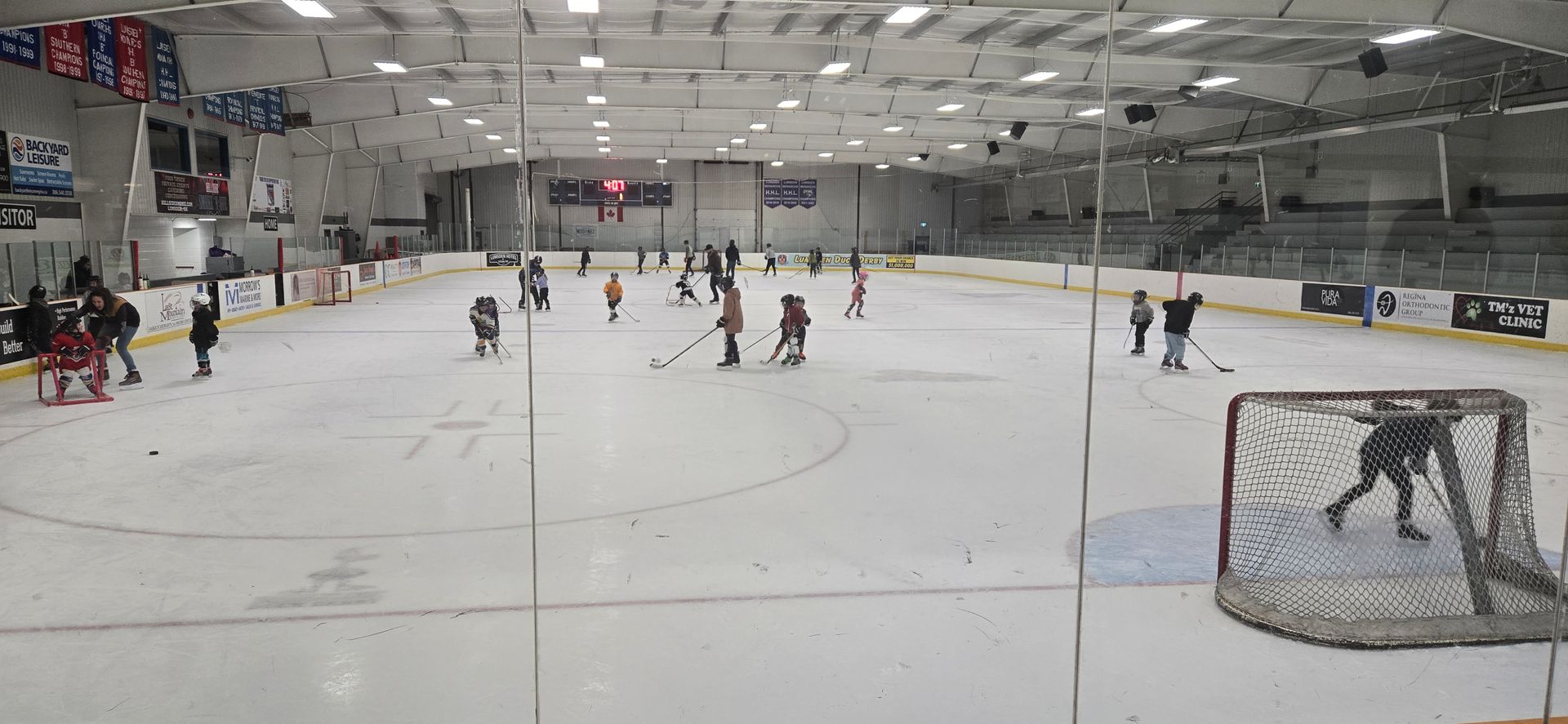 A group of people are playing ice hockey on a rink.