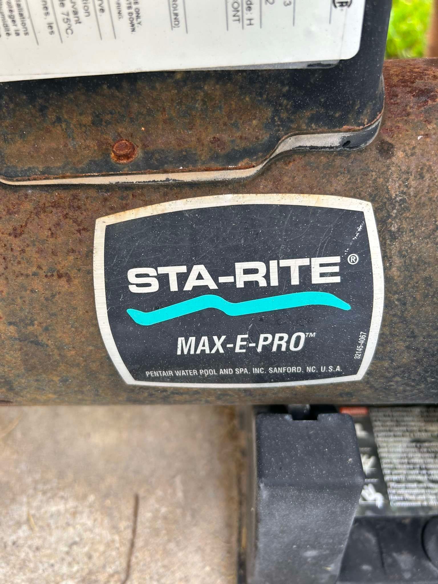 Sta-Rite Max-E-Pro label on pool equipment, black and white with teal wave.