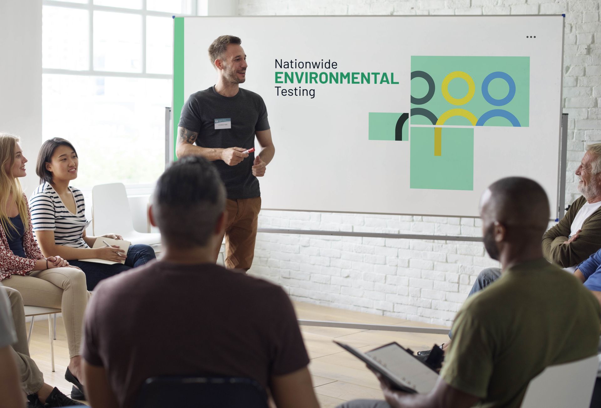 a man is giving a presentation to a group of people sitting in a circle