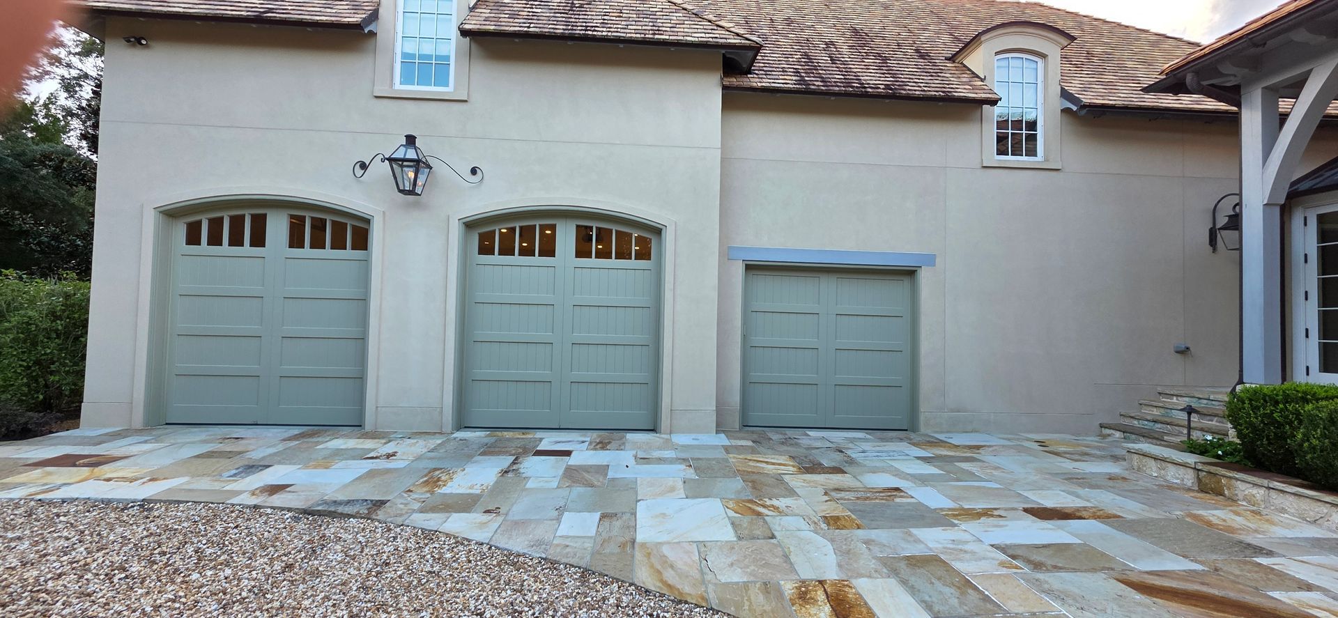 A blue car is parked in a garage with the door open.