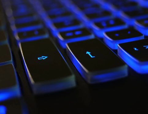 A close up of a computer keyboard with blue keys