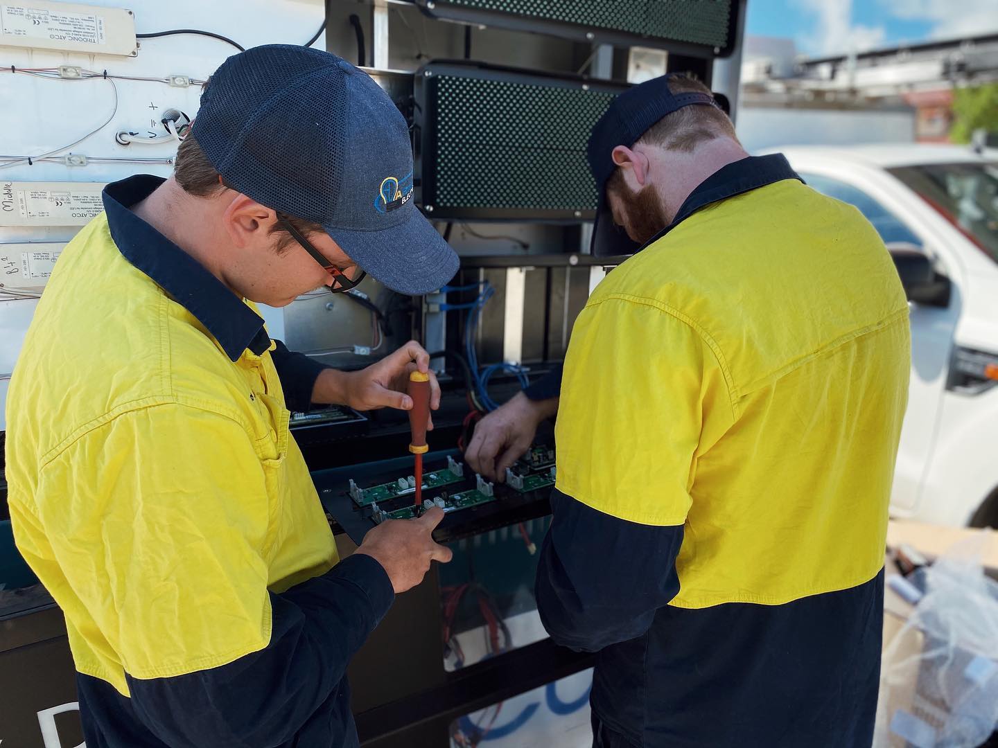 Electricians Replacing Digital Signage — Electrical Contractors in Armidale, NSW