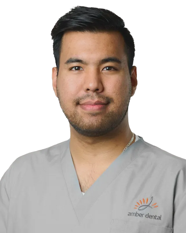 Man wearing gray scrubs with logo 