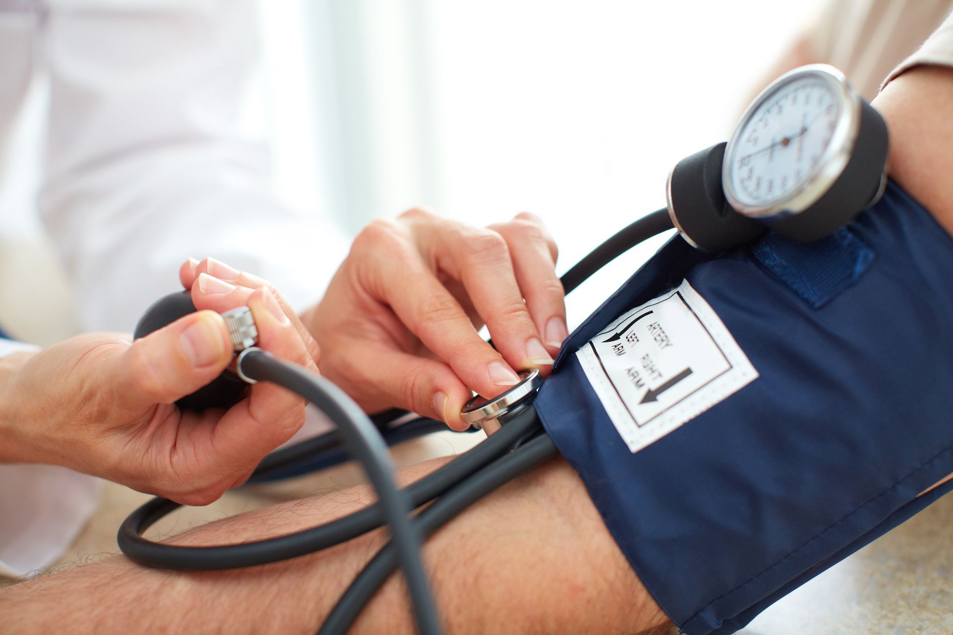Doctor measuring patient's blood pressure
