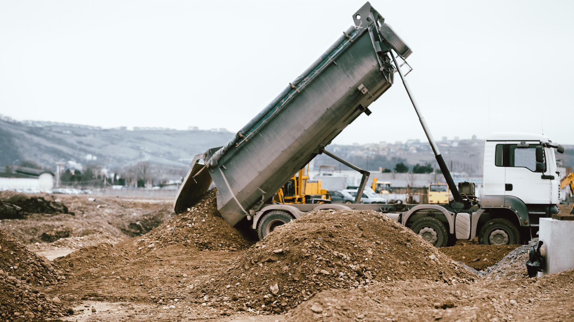 Dumpster truck recycling dirt and gravel in New Mexico