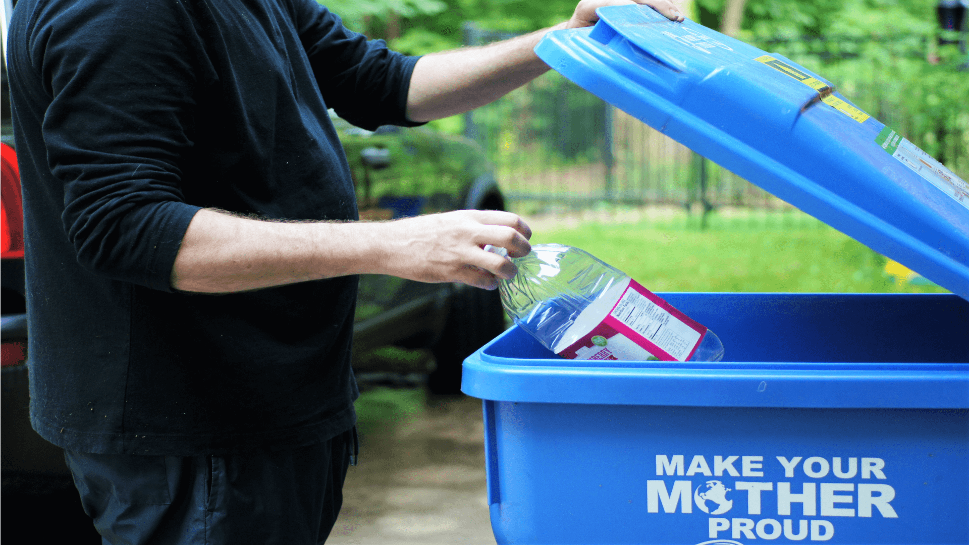 Person throwing out a plastic bottle