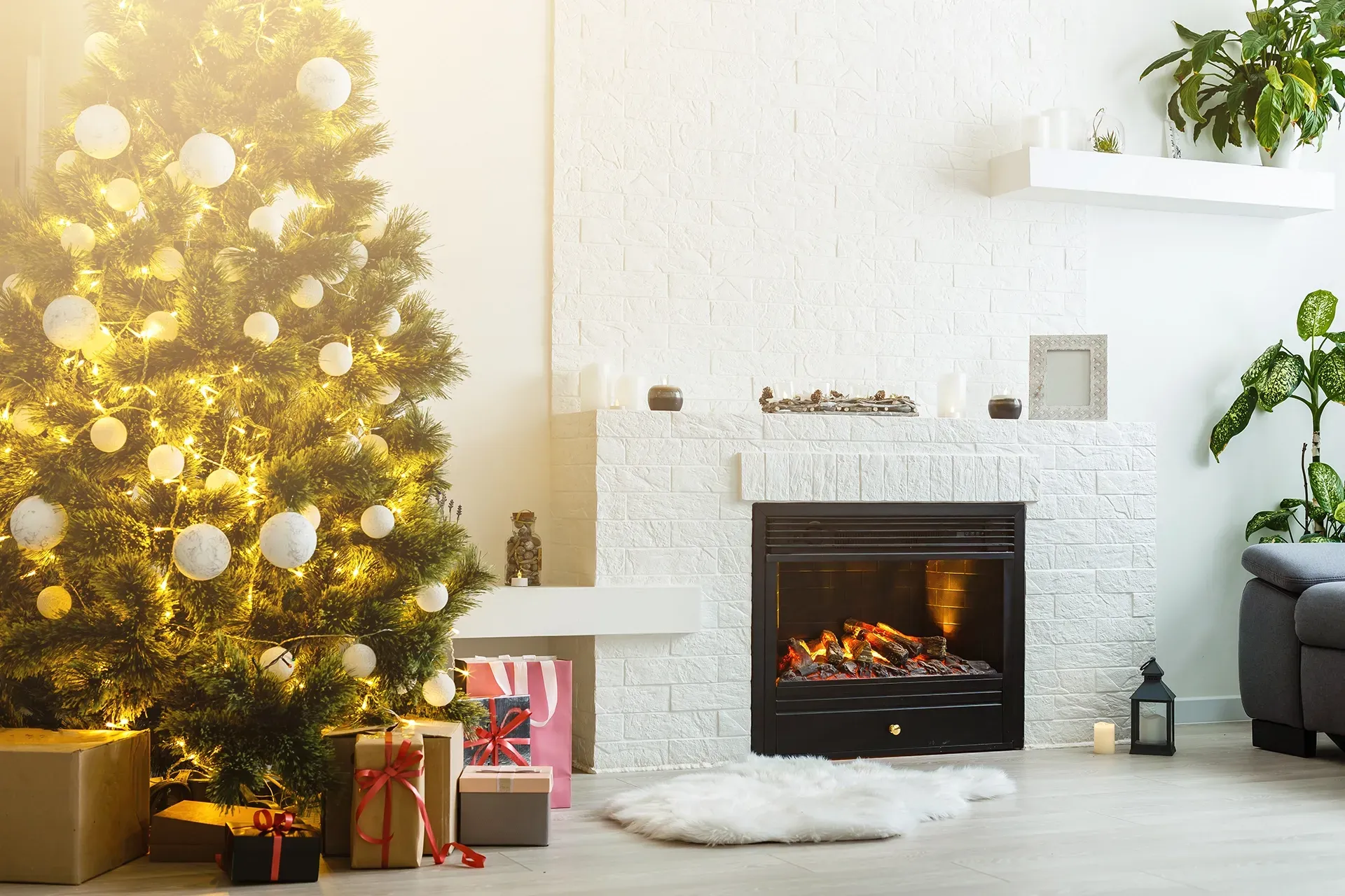 a living room decorated for christmas with a christmas tree and fireplace .