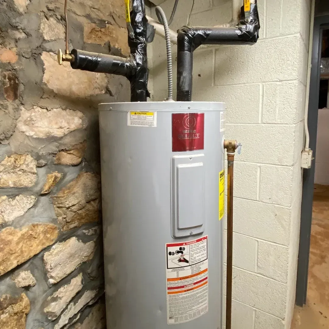 A woman is fixing an under sink water heater in a bathroom.