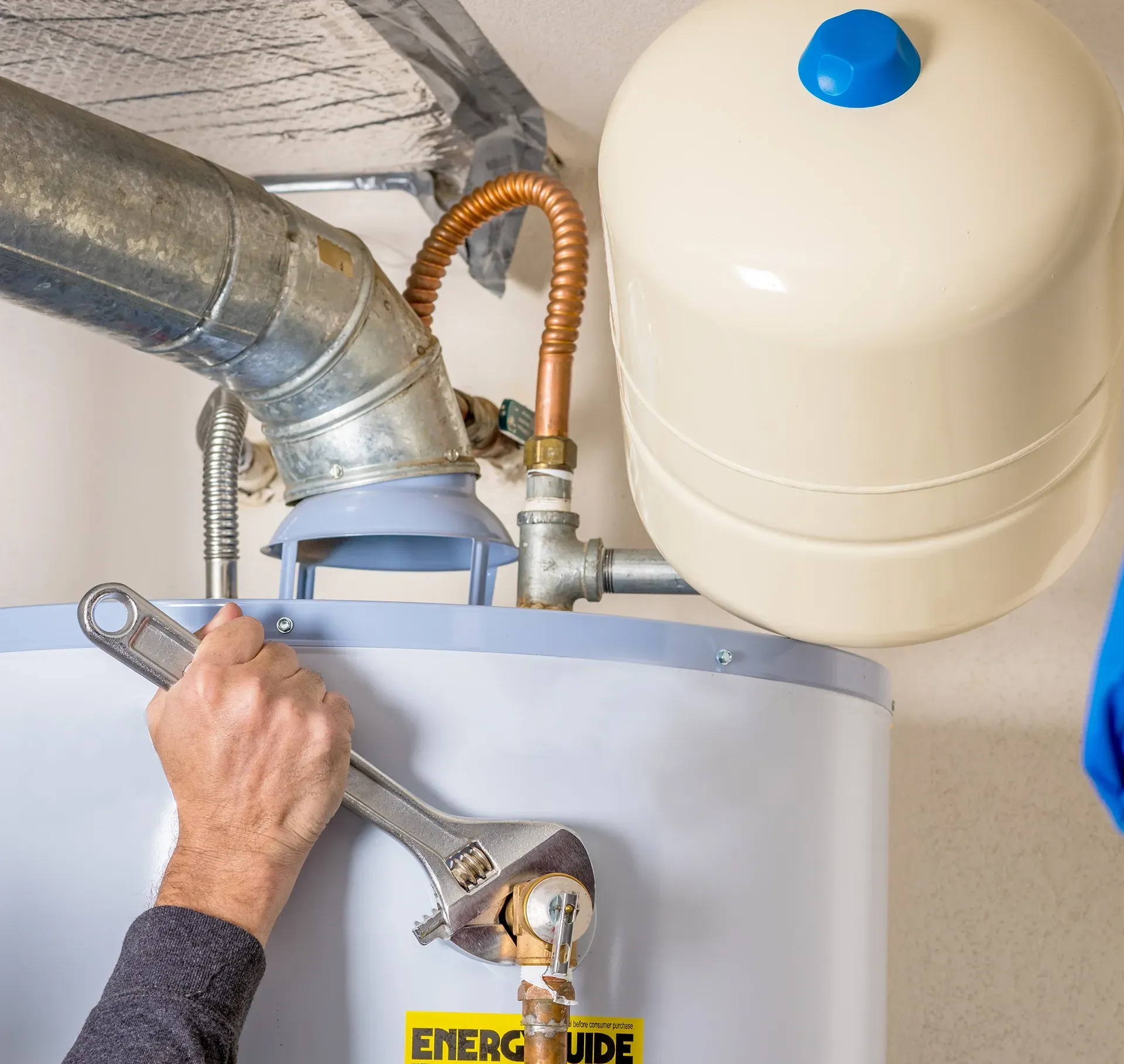 a person is working on an energyguide water heater
