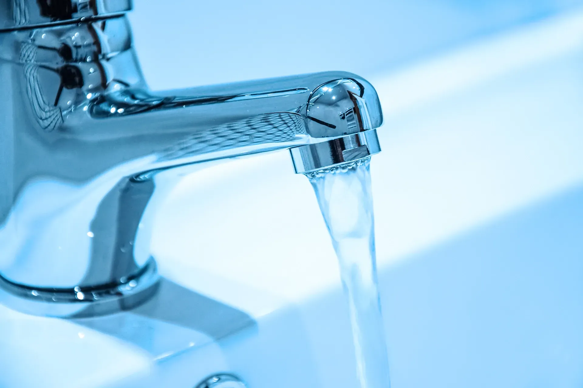 water is running from a faucet into a sink .