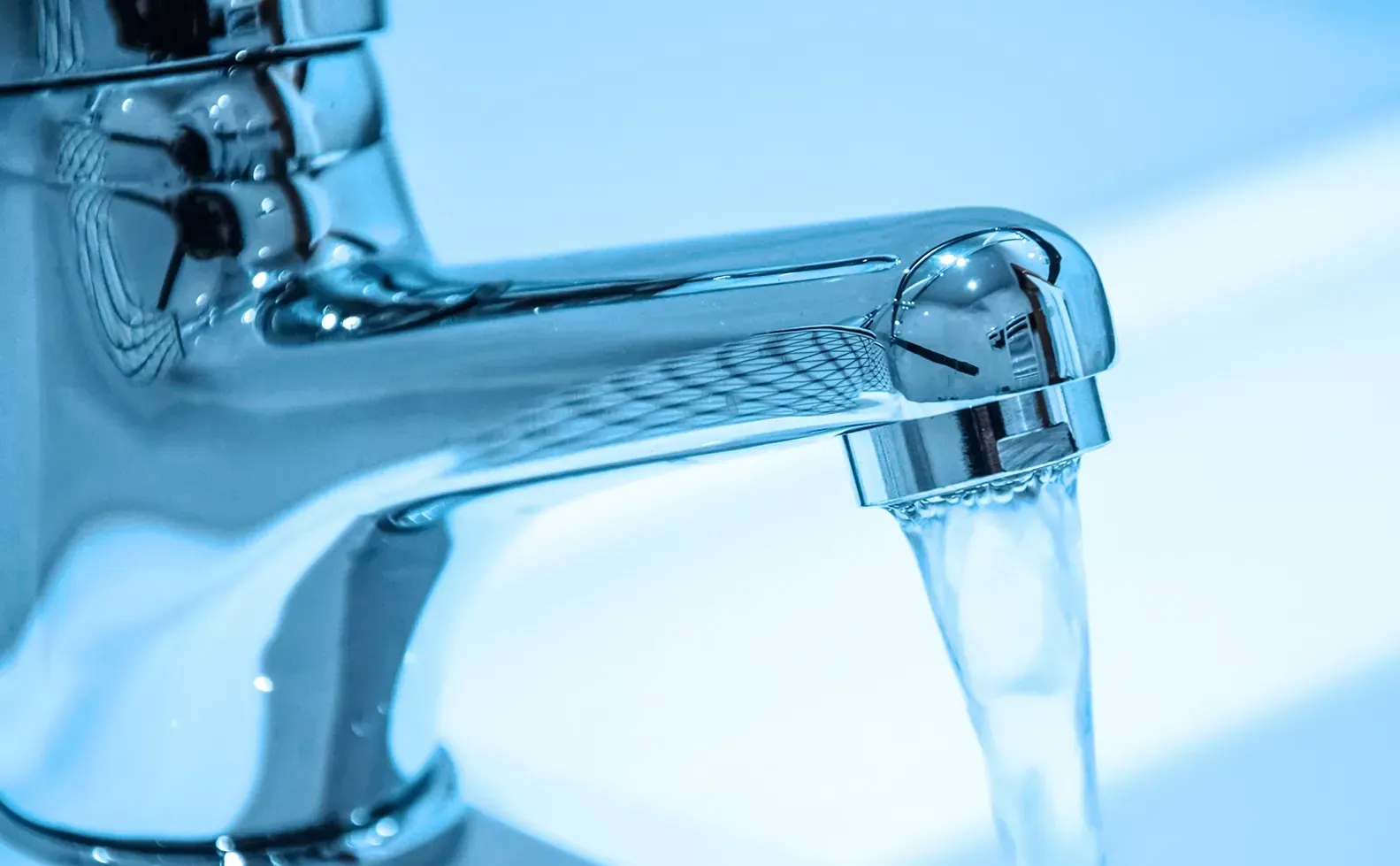 A close up of a faucet with water running out of it.