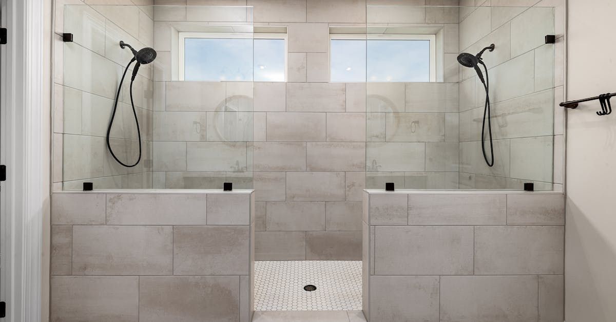 A bathroom with a walk in shower and two shower heads.