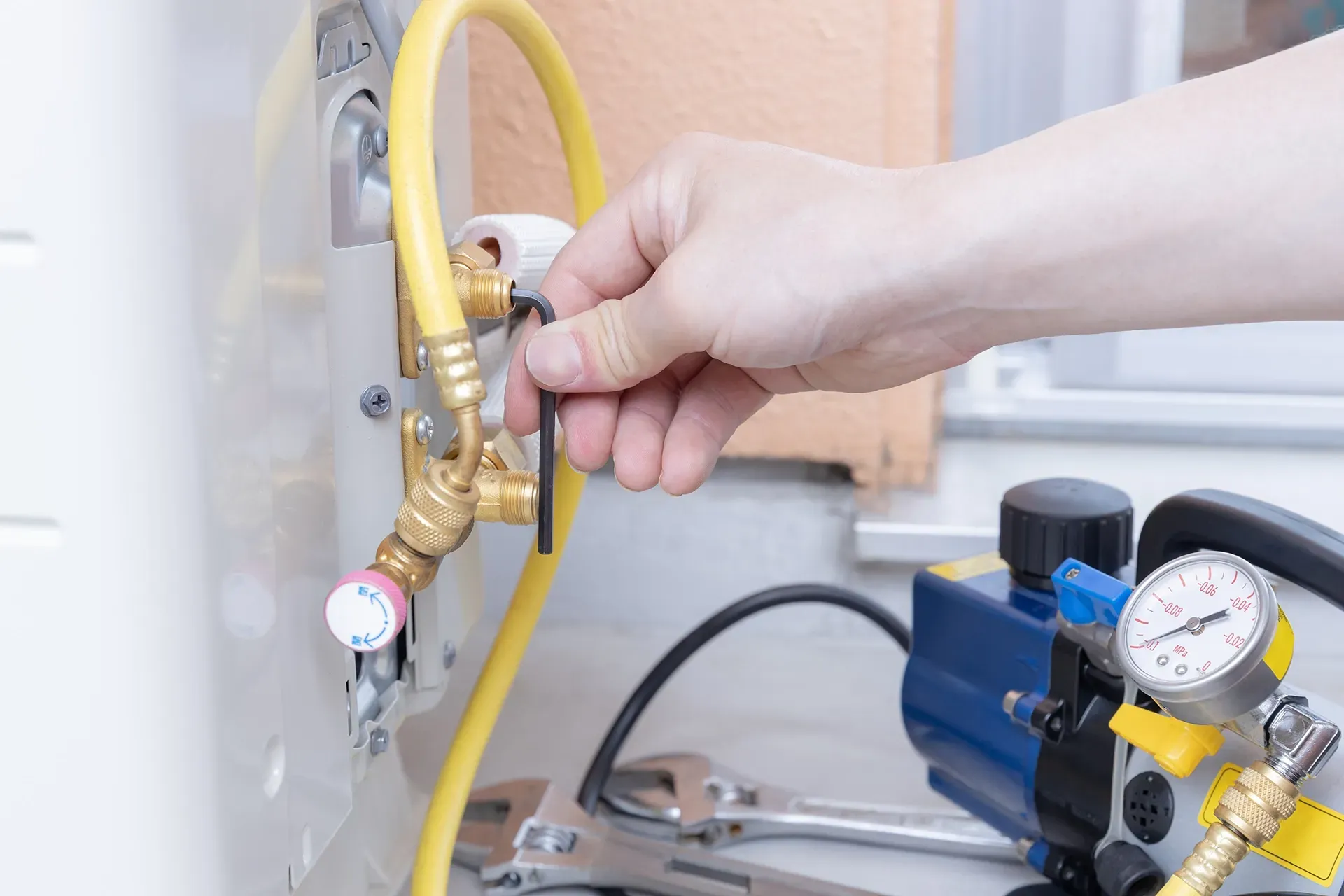 A person is plugging a hose into an pipe