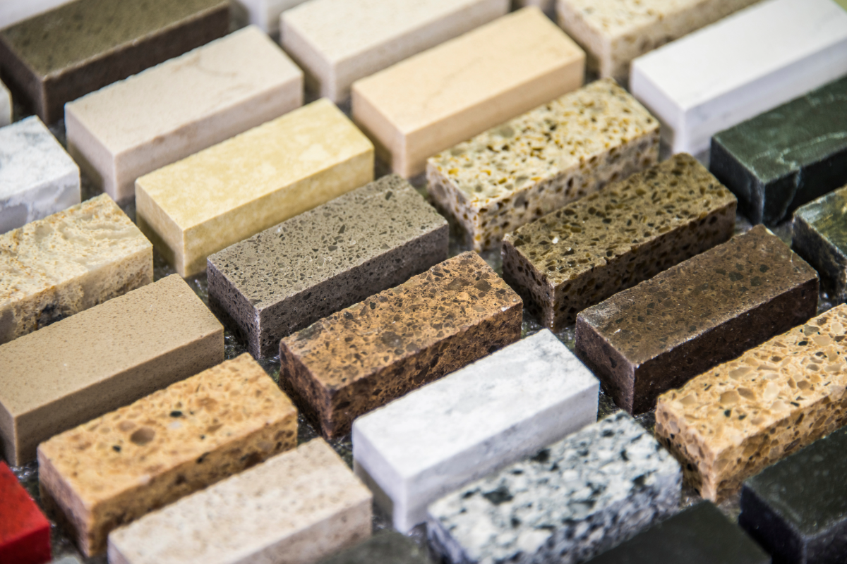 A collection of rectangular stone and marble material samples in various colors and textures arranged in rows.