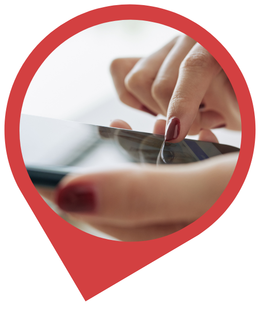 Woman's hands with red nail polish touching a tablet screen.