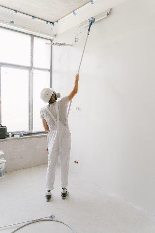 Man With Roller Painting Wall — Sioux Falls, SD — Norberg Paints Man With Roller Painting Wall — Sioux Falls, SD — Norberg Paints