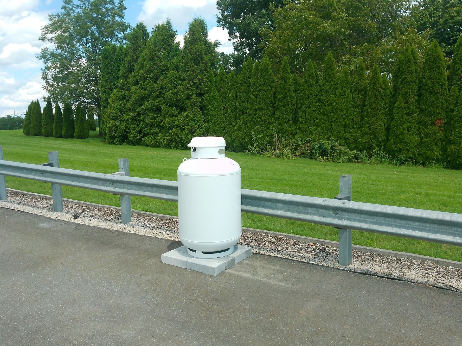 A Propane Tank Is Sitting on The Side of The Road