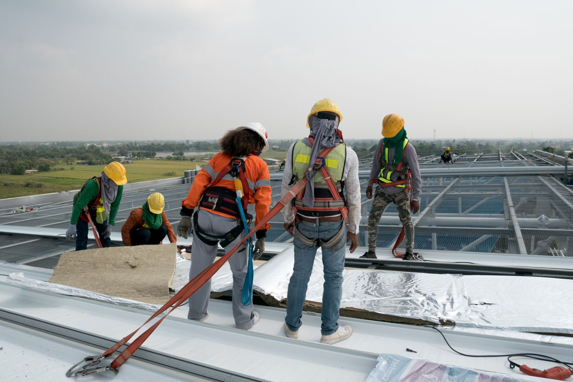 Workers examining roof build