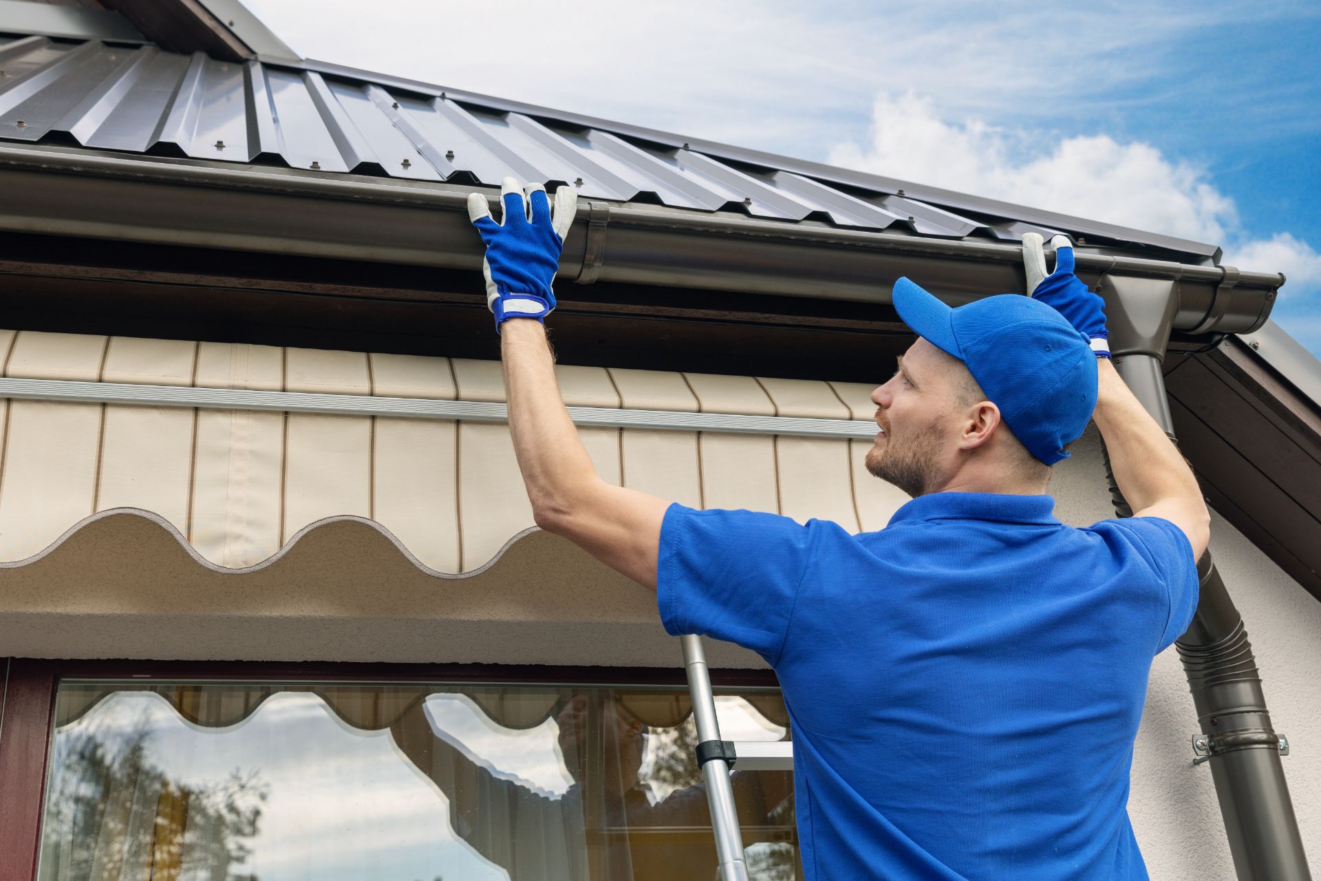 Worker fitting new home gutter