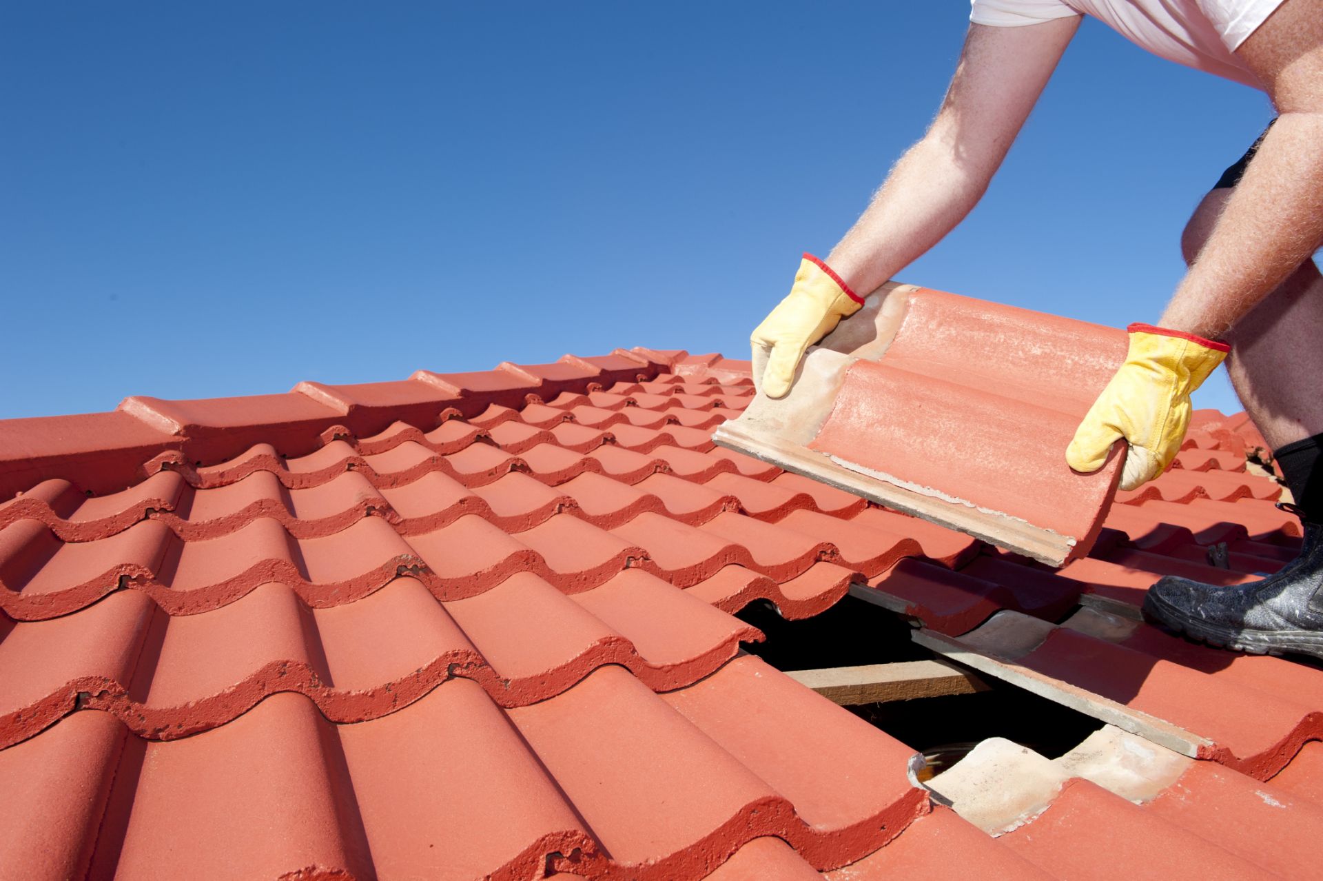 Man installing red brick shingle