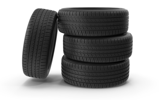 Four tires are stacked on top of each other on a white background.